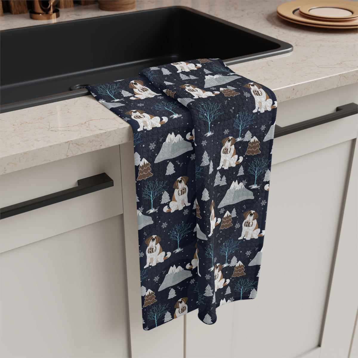 Alpine Chill Saint Bernard microfiber tea towel with a navy print of Saint Bernards with rescue barrels among frosty trees and snowy mountains.