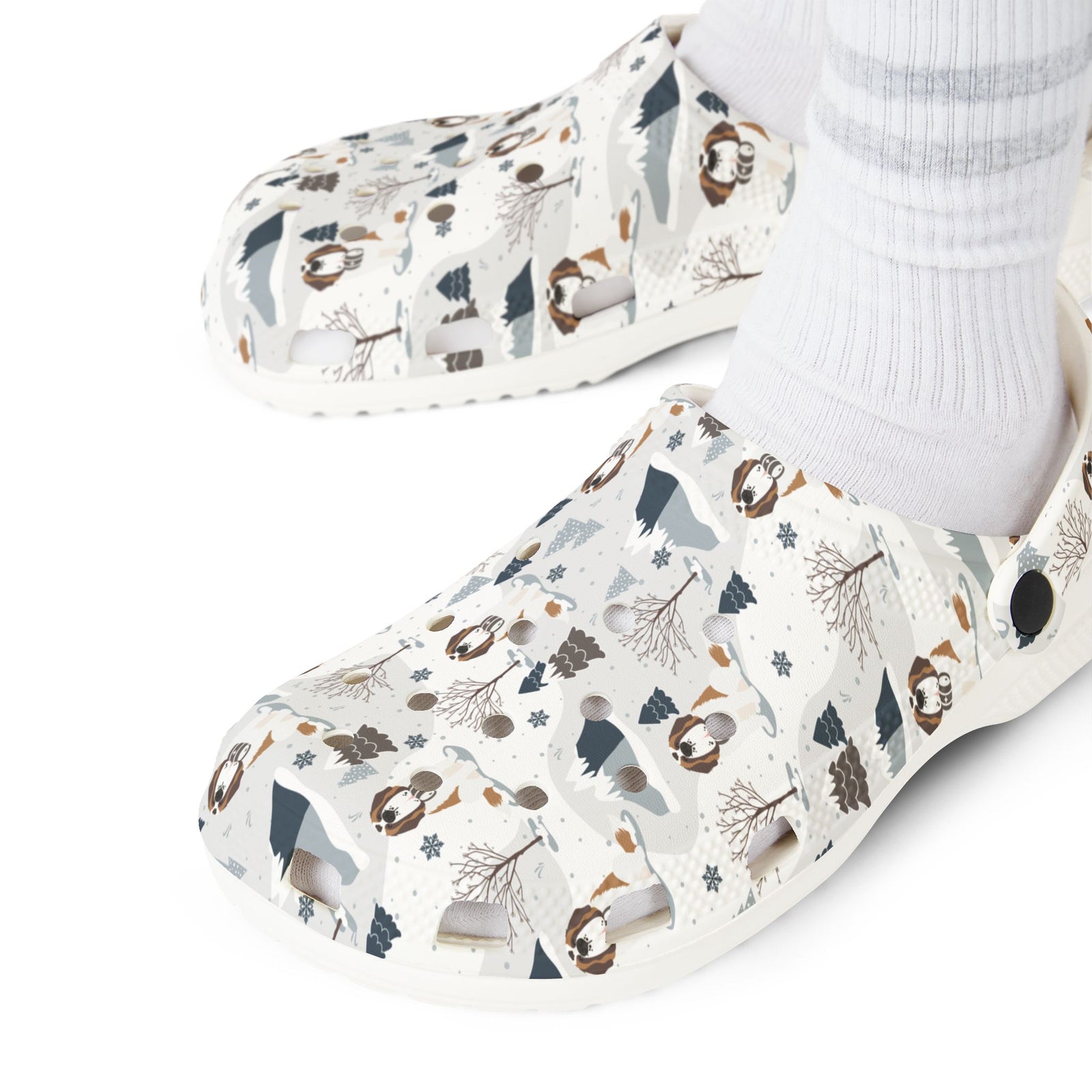 White EVA clog shoes with an all-over alpine mountain pattern featuring pines and Saint Bernards by Lucy and Norman