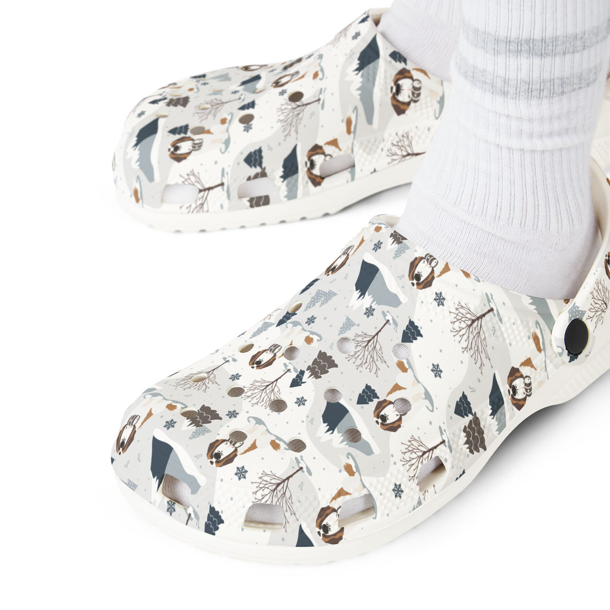 White EVA clog shoes with an all-over alpine mountain pattern featuring pines and Saint Bernards by Lucy and Norman