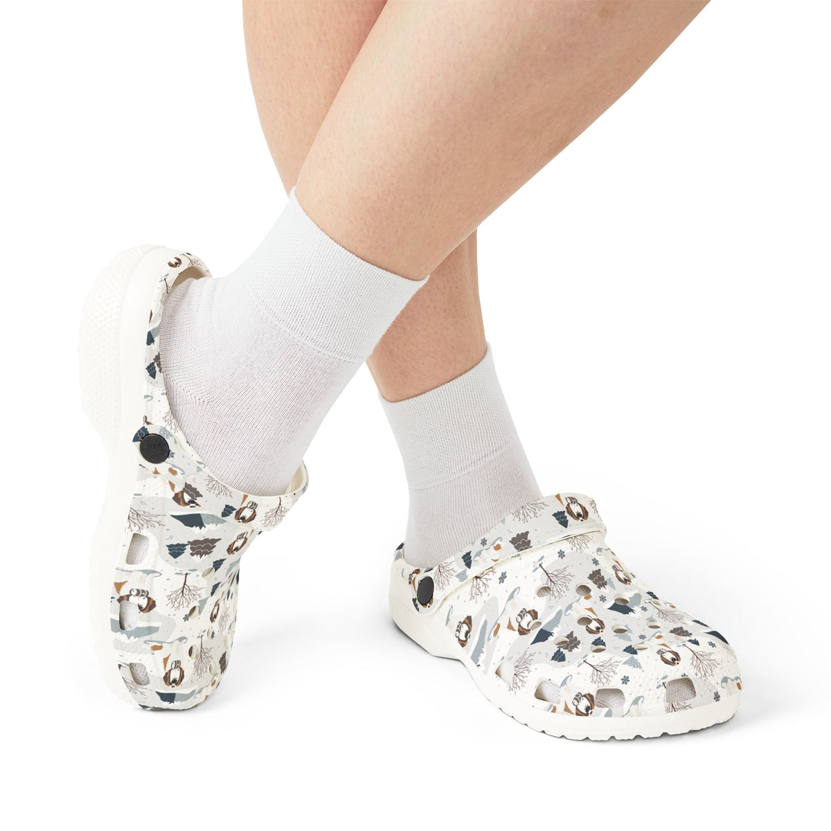 White EVA clog shoes with an all-over alpine mountain pattern featuring pines and Saint Bernards by Lucy and Norman