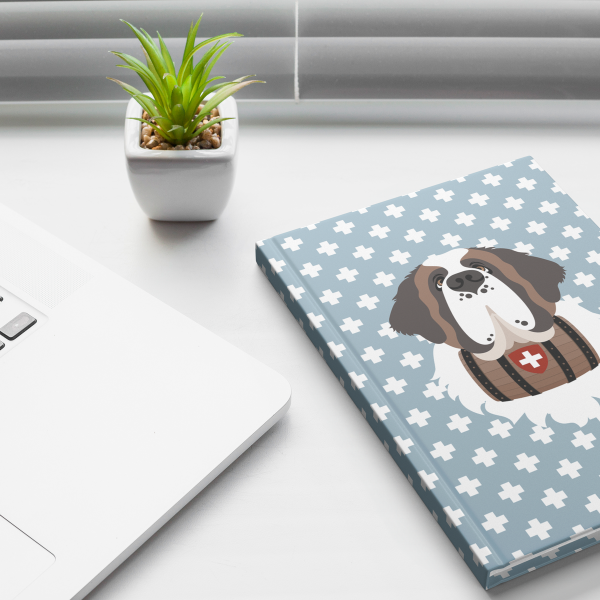 Swiss Cross Blue Saint Bernard hardcover lined journal with a dusty-blue cover featuring a Saint Bernard and rescue barrel among white Swiss crosses.