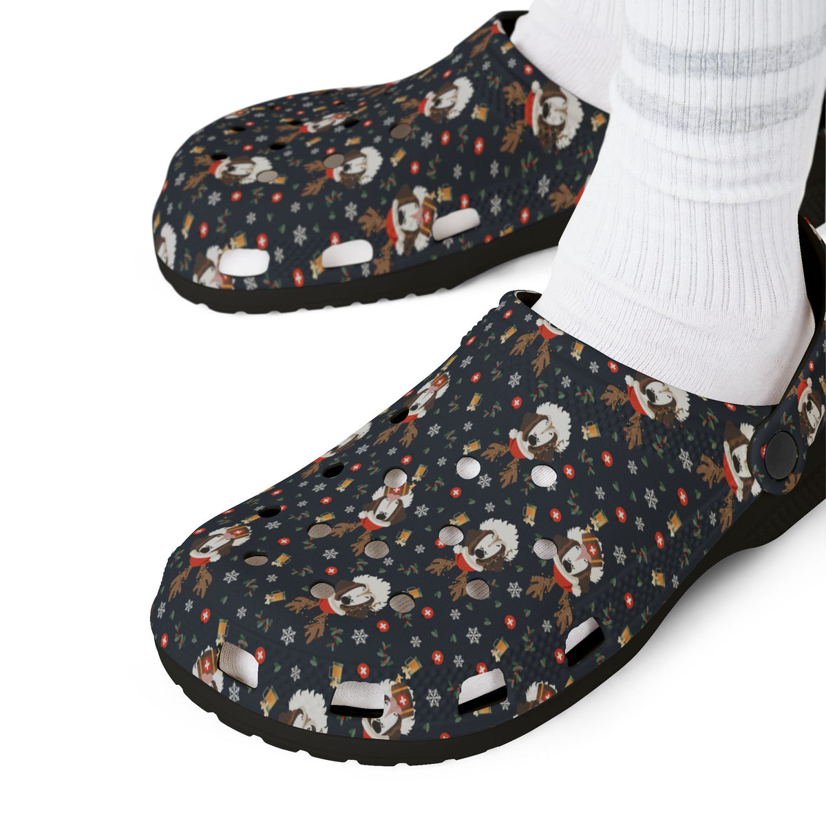Black rubber clog shoes with an all-over navy holiday print of Saint Bernards wearing reindeer antlers, beer barrels, and snowflakes by Lucy and Norman