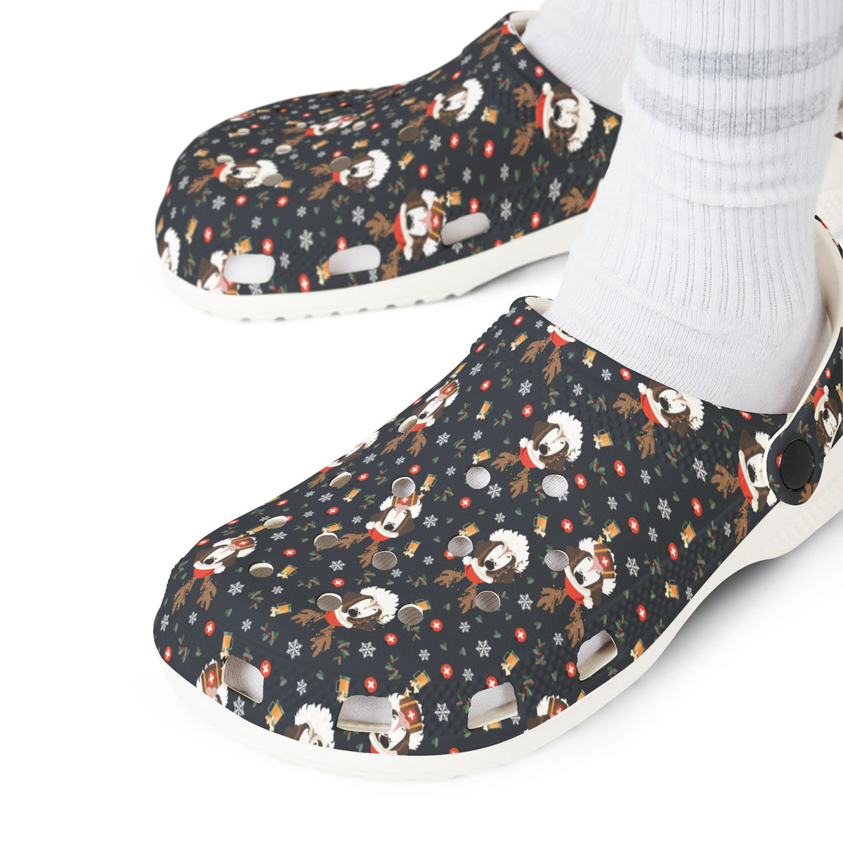 White rubber clog shoes with an all-over navy holiday print of Saint Bernards wearing reindeer antlers, beer barrels, and snowflakes by Lucy and Norman