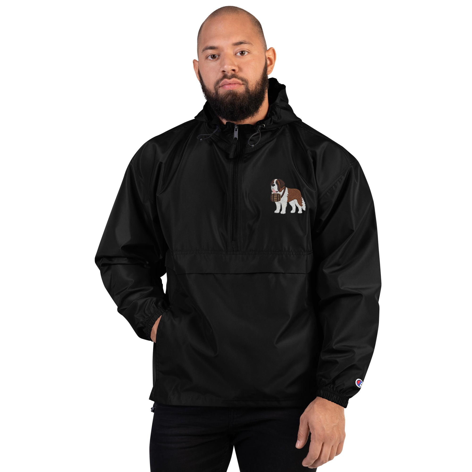 Black Champion packable windbreaker with chest embroidered Saint Bernard and barrel, half zip pullover with hood, kangaroo pocket, and zip pouch.