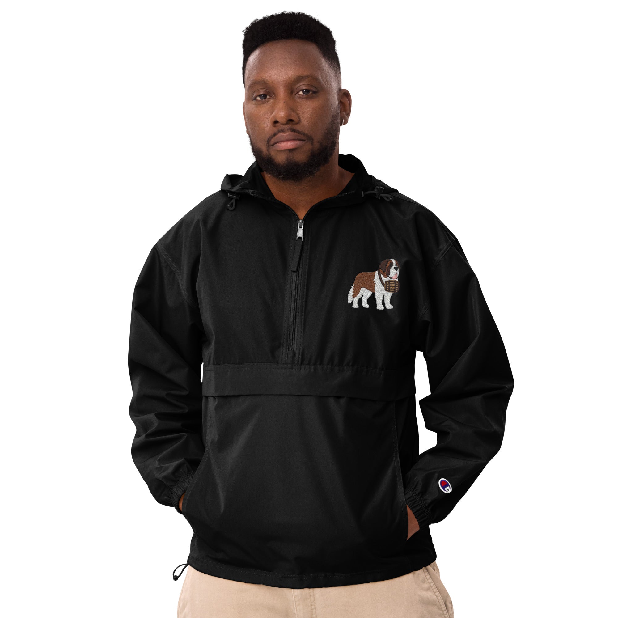Black Champion packable windbreaker with chest embroidered Saint Bernard and barrel, half zip pullover with hood, kangaroo pocket, and zip pouch.