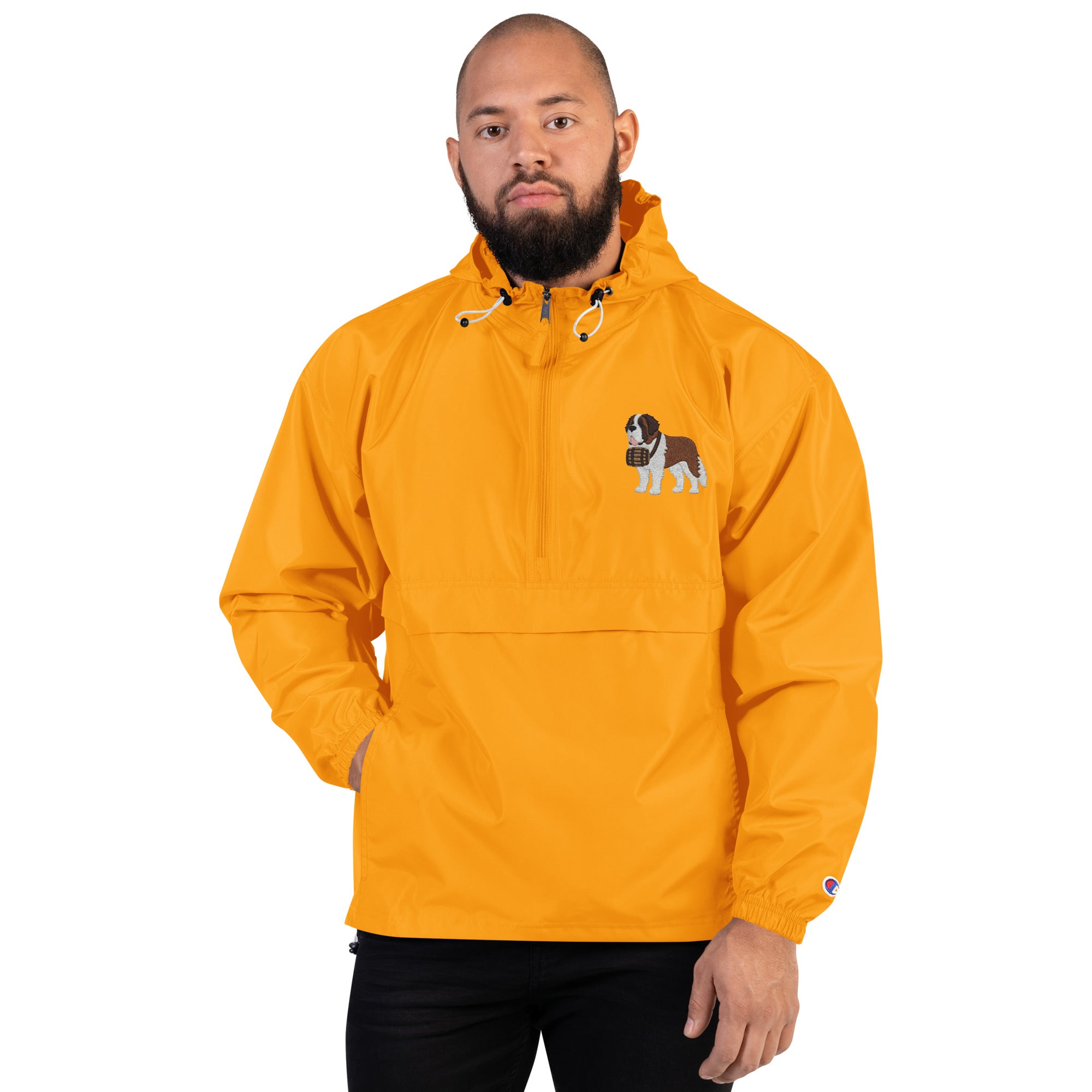 Gold Champion packable windbreaker with chest embroidered Saint Bernard and barrel, half zip pullover with hood, kangaroo pocket, and zip pouch.