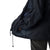 Lightweight, packable navy blue windbreaker with chest embroidered Saint Bernard and barrel, adjustable hood, elastic cuffs, and zip pockets.