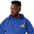 Royal blue Champion packable windbreaker with chest embroidered Saint Bernard and barrel, half zip pullover with hood, kangaroo pocket, and zip pouch.