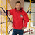 Red Champion packable windbreaker with chest embroidered Saint Bernard and barrel, half zip pullover with hood, kangaroo pocket, and zip pouch.