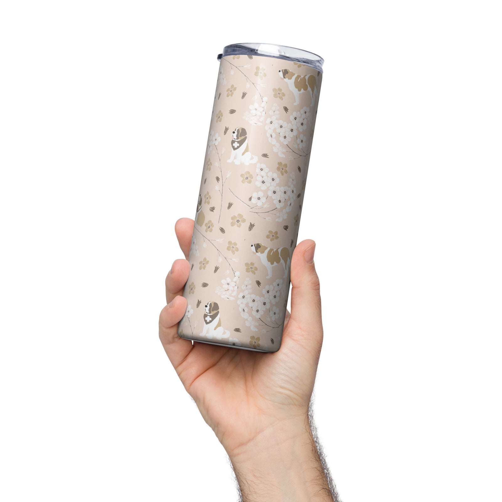 Stainless steel Forget Me Not Saint Bernard skinny tumbler with a blush finish featuring Saint Bernards among delicate white and golden florals, with a lid and metal straw.