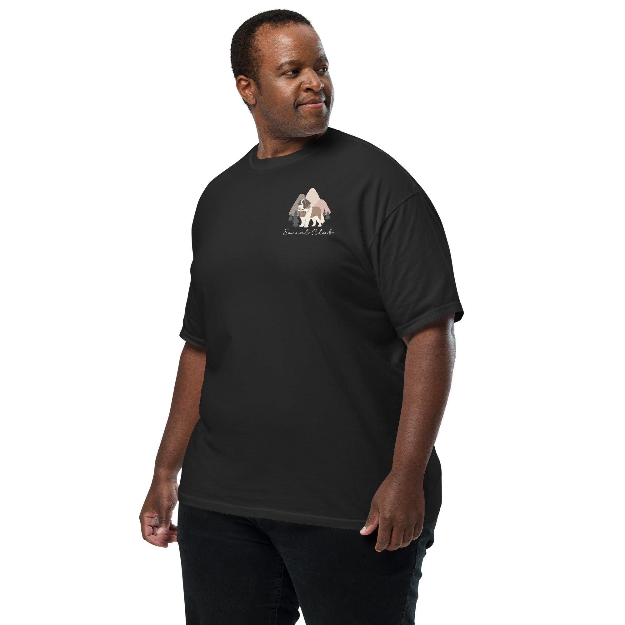 Comfort Colors black t-shirt featuring a woodland-mountain theme with Saint Bernard dogs on the back with a badge on left chest. Perfect Saint Bernard gift for dog lovers.