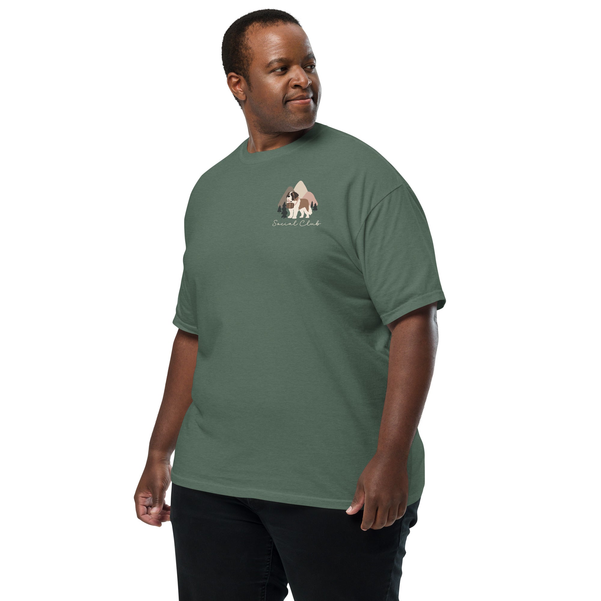 Comfort Colors blue spruce t-shirt featuring a woodland-mountain theme with Saint Bernard dogs on the back with a badge on left chest. Perfect Saint Bernard gift for dog lovers.