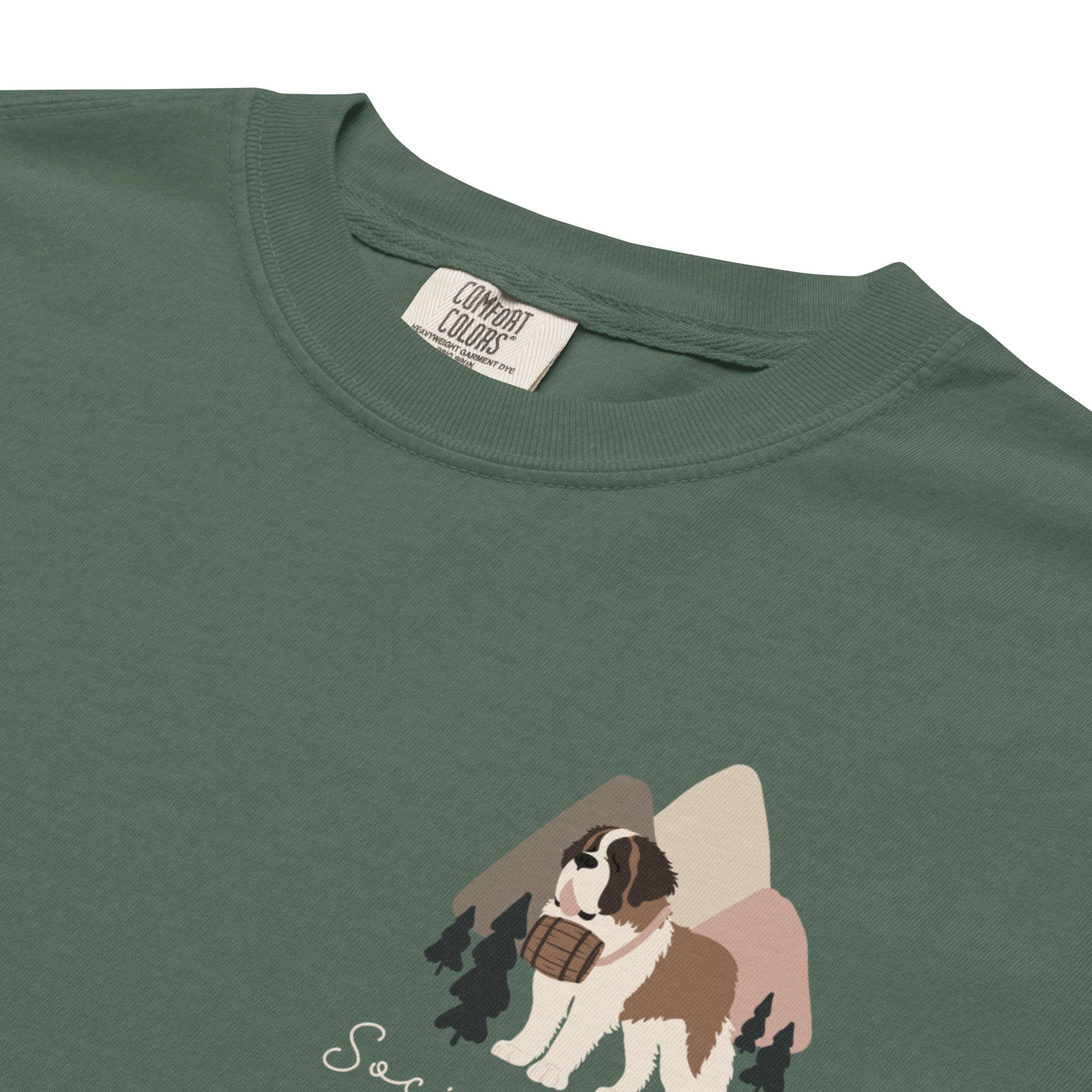 Comfort Colors blue spruce t-shirt featuring a woodland-mountain theme with Saint Bernard dogs on the back with a badge on left chest. Perfect Saint Bernard gift for dog lovers.