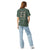 Comfort Colors blue spruce t-shirt featuring a woodland-mountain theme with Saint Bernard dogs on the back with a badge on left chest. Perfect Saint Bernard gift for dog lovers.