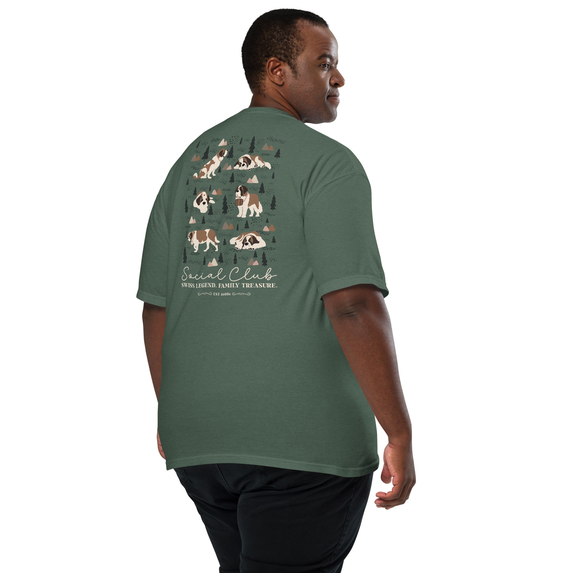 Comfort Colors blue spruce t-shirt featuring a woodland-mountain theme with Saint Bernard dogs on the back with a badge on left chest. Perfect Saint Bernard gift for dog lovers.