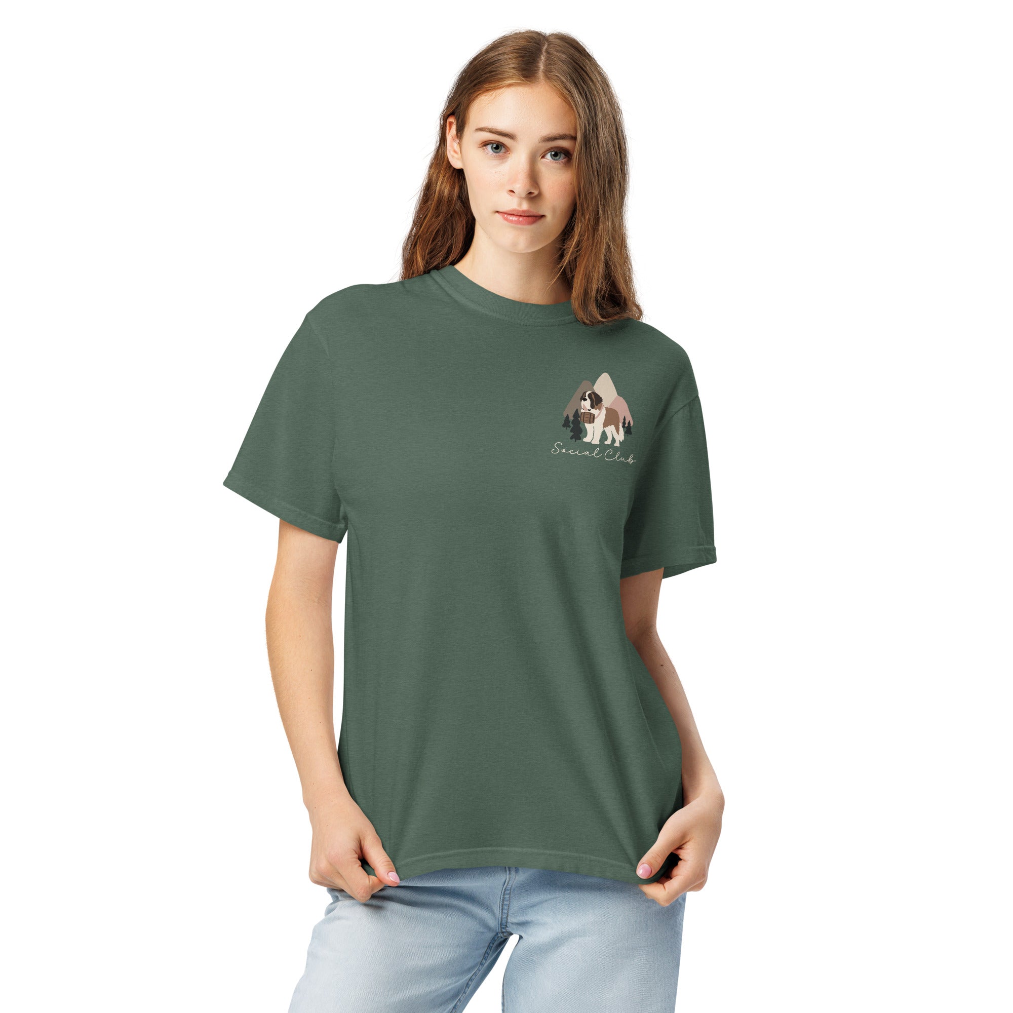 Comfort Colors blue spruce t-shirt featuring a woodland-mountain theme with Saint Bernard dogs on the back with a badge on left chest. Perfect Saint Bernard gift for dog lovers.