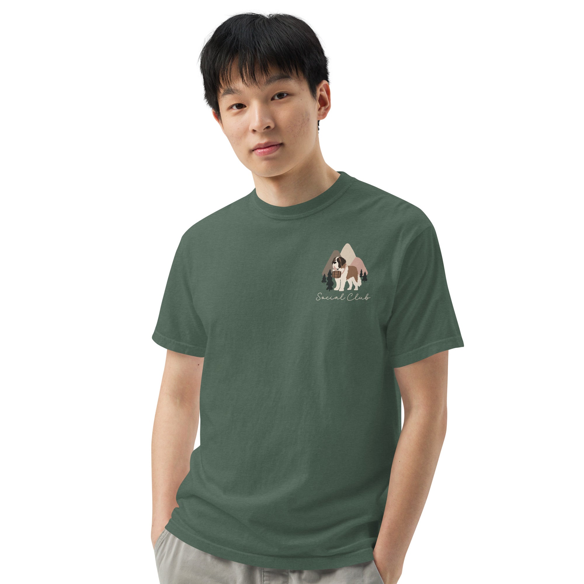 Comfort Colors blue spruce t-shirt featuring a woodland-mountain theme with Saint Bernard dogs on the back with a badge on left chest. Perfect Saint Bernard gift for dog lovers.