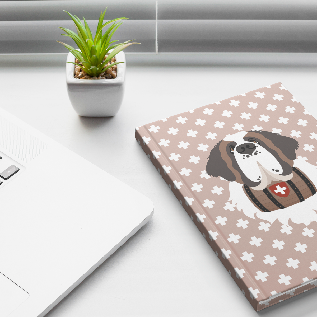 Swiss Cross Pink Saint Bernard hardcover lined journal with a soft pink cover featuring a Saint Bernard and rescue barrel among white Swiss crosses.