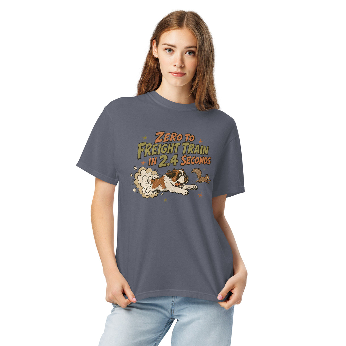 Denim blue Comfort Colors t-shirt with a retro earth tone cartoon of a funny Saint Bernard chasing a squirrel and Zero to Freight Train in 2.4 Seconds lettering.