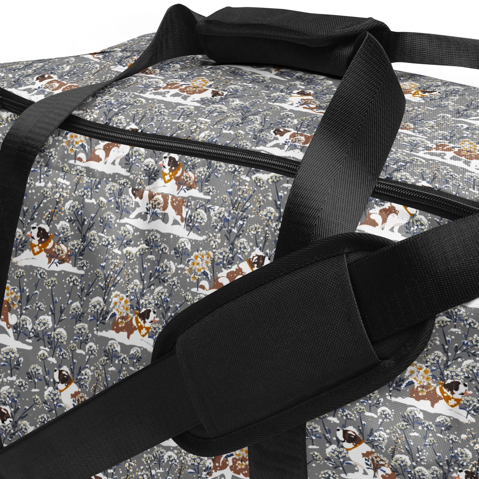 Snowflowers Saint Bernard floral duffle bag in soft gray, blue, white, and winter floral tones with padded black shoulder strap, handles, zip compartment, and mesh side pocket.