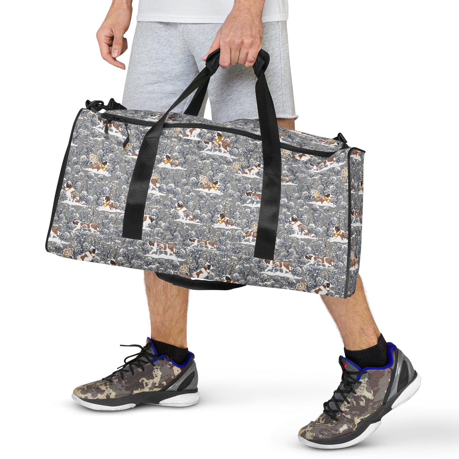 Snowflowers Saint Bernard floral duffle bag in soft gray, blue, white, and winter floral tones with padded black shoulder strap, handles, zip compartment, and mesh side pocket.