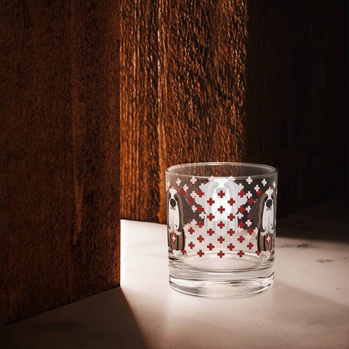 10.5 once rock glass drinkware with a modern pattern of Swiss inspired red crosses and a cute large Saint Bernard dog head with a barrel by Lucy and Norman