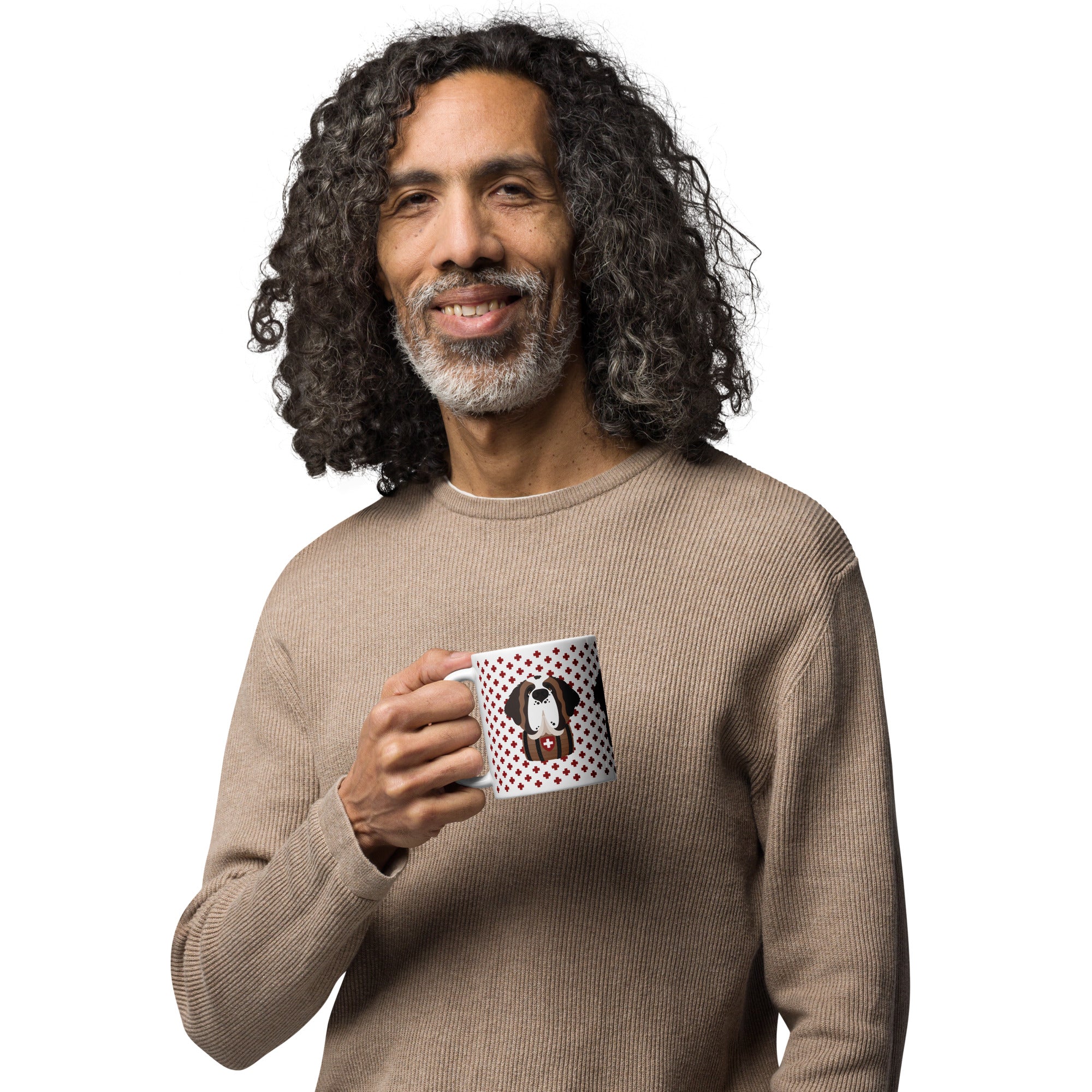 White ceramic 11 ounce mug featuring a cute illustrated Saint Bernard dog wearing a rescue barrel, surrounded by a red Swiss cross pattern. Perfect gift for St Bernard dog lovers and Swiss Alps fans by Lucy and Norman.