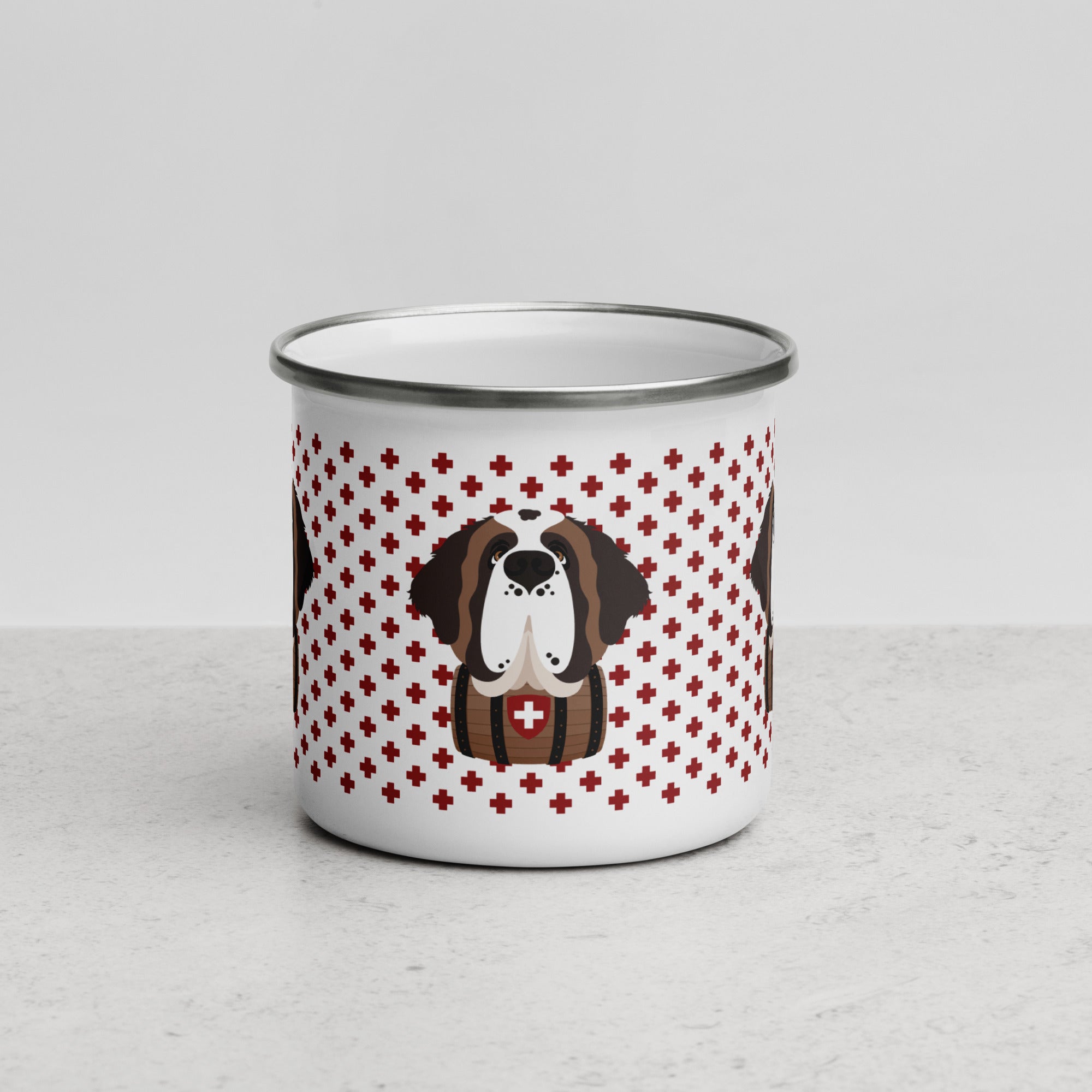 White enamel 12 ounce camp mug with silver rim featuring a cute illustrated Saint Bernard dog wearing a rescue barrel, surrounded by a red Swiss cross pattern. Perfect gift for St Bernard dog lovers and Swiss Alps fans by Lucy and Norman.