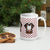 White ceramic 15 ounce mug featuring a cute illustrated Saint Bernard dog wearing a rescue barrel, surrounded by a red Swiss cross pattern. Perfect gift for St Bernard dog lovers and Swiss Alps fans by Lucy and Norman.