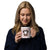 White ceramic 20 ounce mug featuring a cute illustrated Saint Bernard dog wearing a rescue barrel, surrounded by a red Swiss cross pattern. Perfect gift for St Bernard dog lovers and Swiss Alps fans by Lucy and Norman.