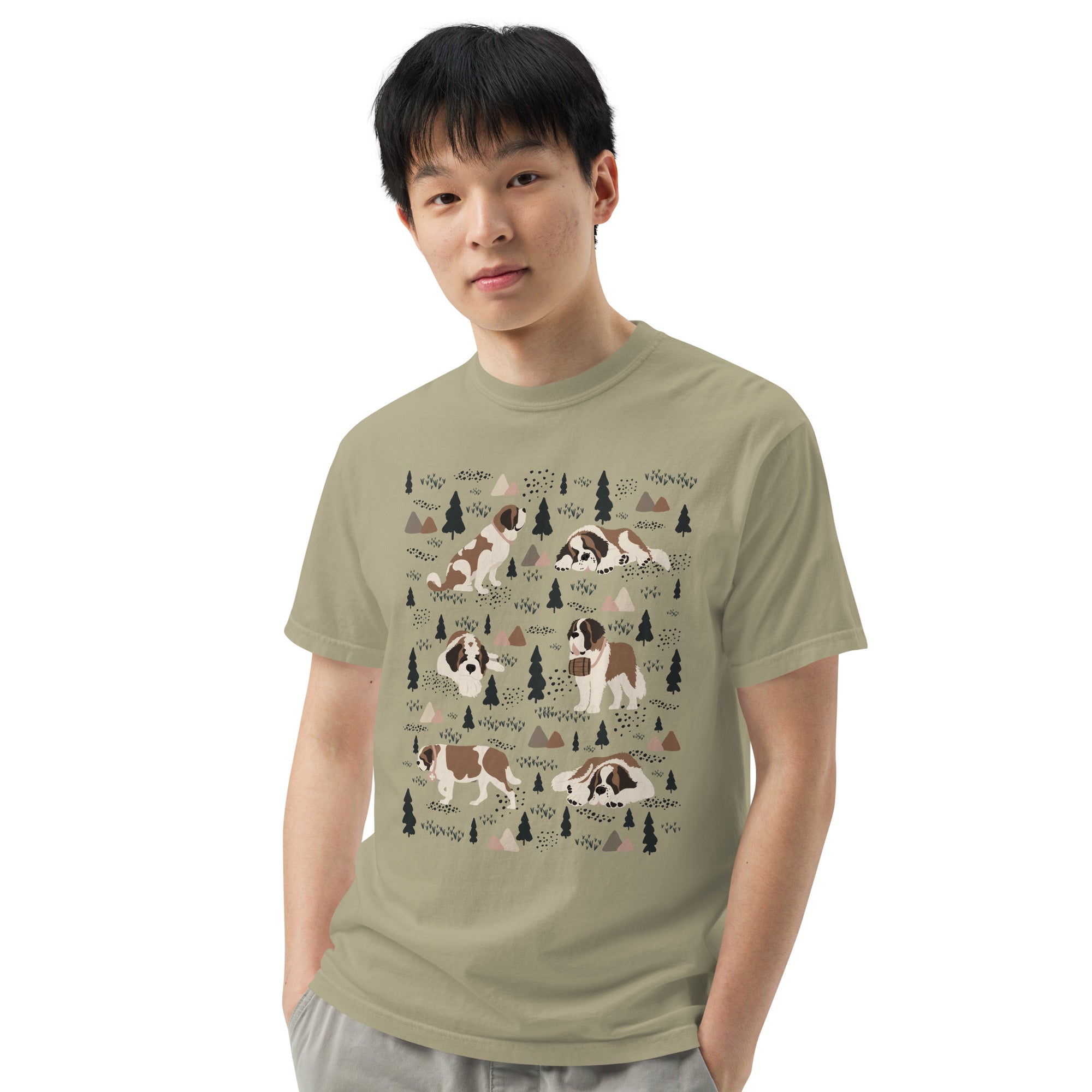 Comfort Colors Khaki t-shirt featuring a woodland-themed Saint Bernard dog woodland and mountains pattern with six adorable Saint Bernards in various poses, perfect Saint Bernard gift for dog lovers.