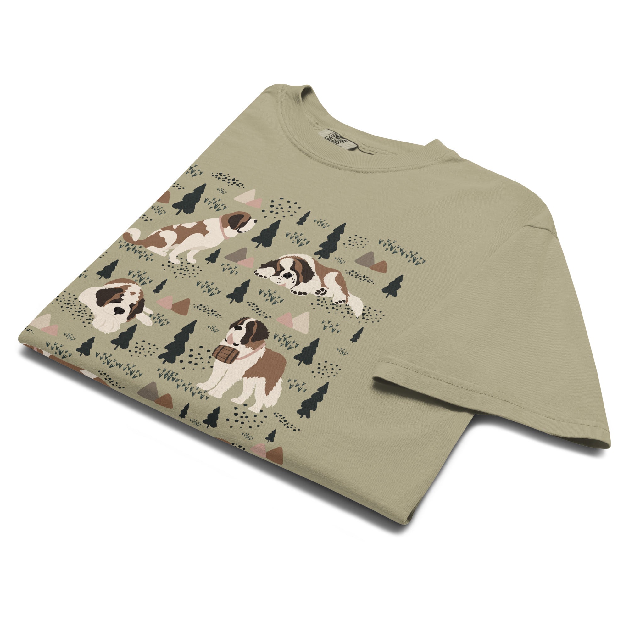Comfort Colors Khaki t-shirt featuring a woodland-themed Saint Bernard dog woodland and mountains pattern with six adorable Saint Bernards in various poses, perfect Saint Bernard gift for dog lovers.