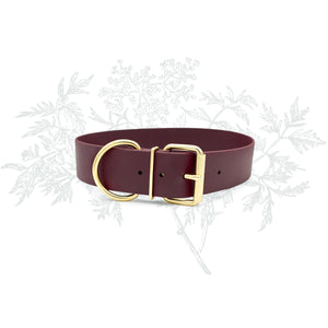 Photo of a 1.5 inch wide burgundy red BioThane® dog collar with solid brass metal hardware and a classic roller buckle that is waterproof and stink proof on a white background by Lucy and Norman